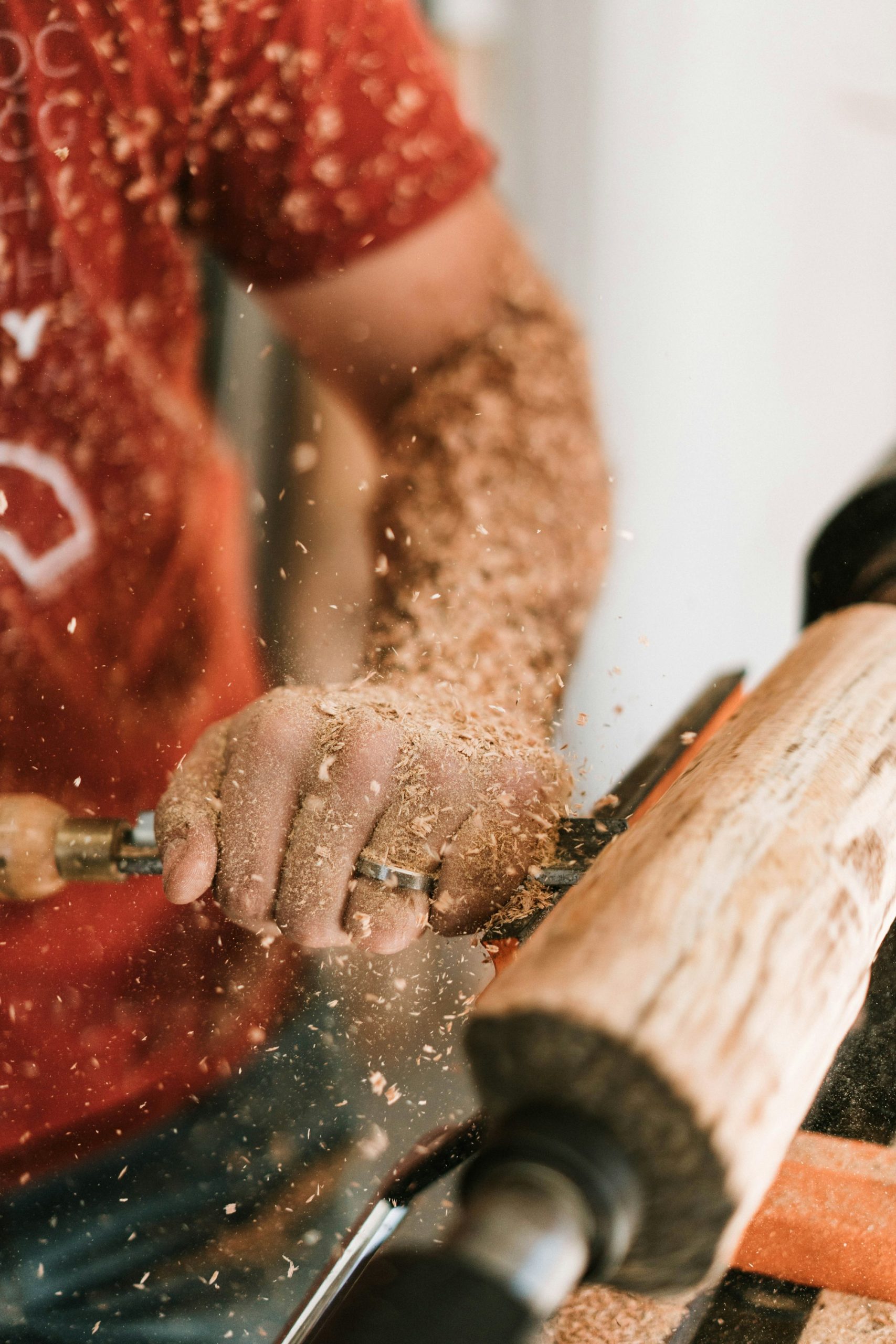 A Supreme Woods craftsman shaping teak
